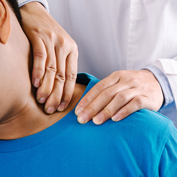 Doctor physiotherapist diagnosing patient with painful shoulder