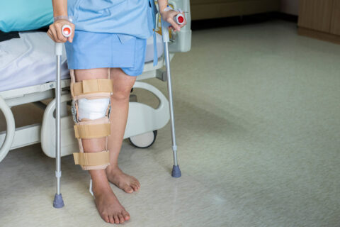 Person with knee injury using crutches to stand in medical facility in Grapevine, Texas