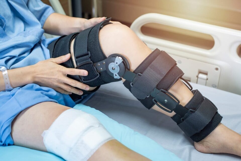 Person in hospital bed with leg brace on in Texas