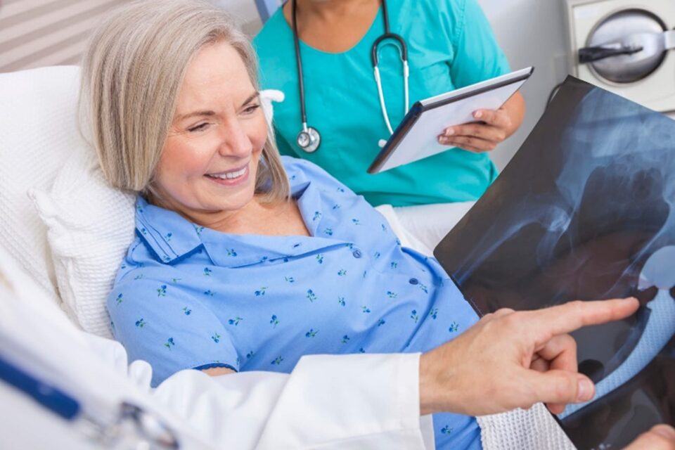 Woman and health professionals look at hip xray in DFW Texas